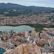 Seagulls on the summit of 332 meters high Penyal D'Ifac with the town Calp